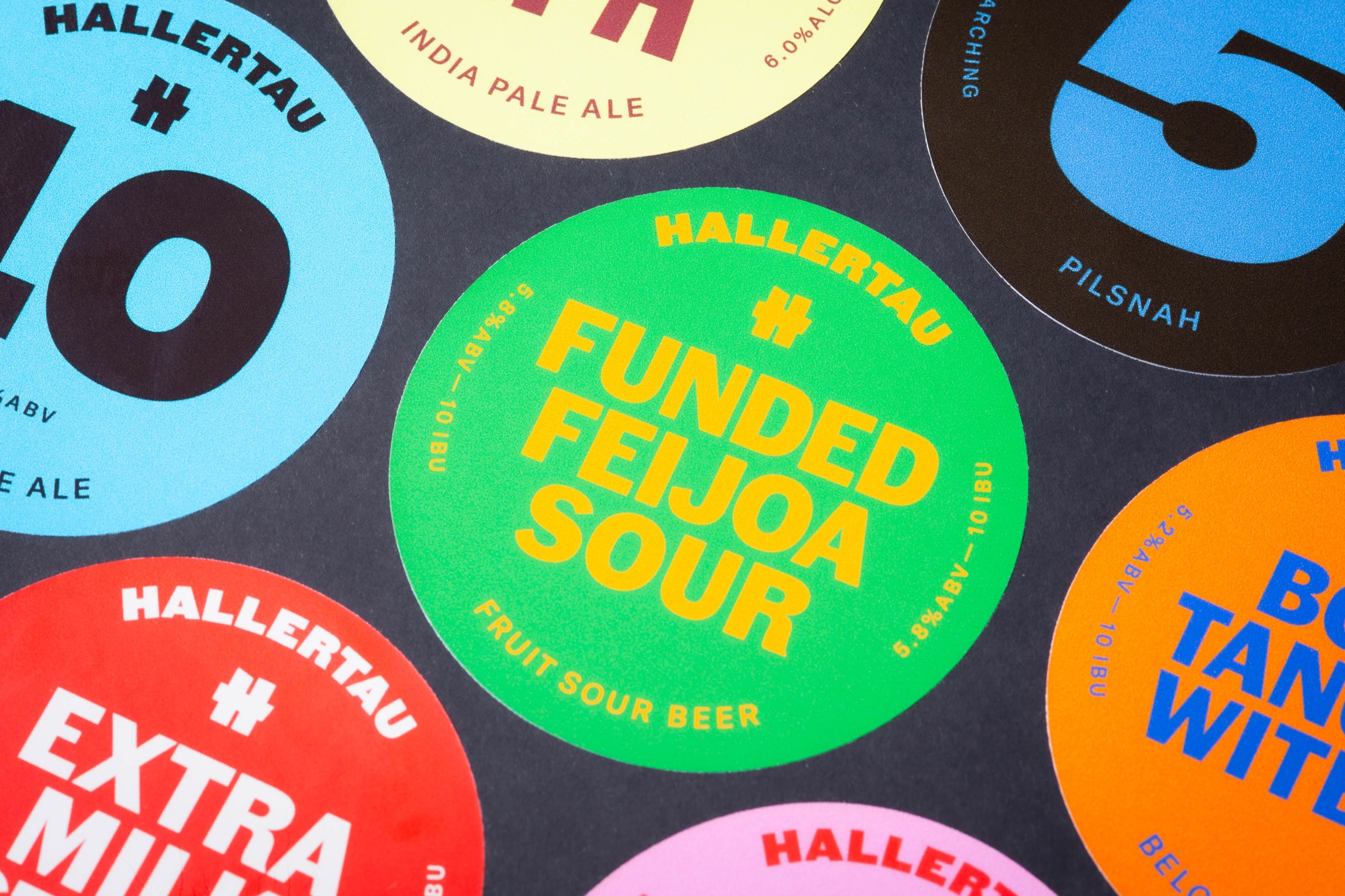Custom printed tap badges for Hallertau Brewery, removable vinyl with bold colour graphics.